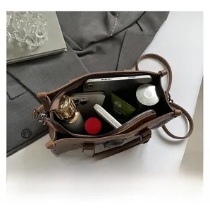 Interior view showing the large capacity of the brown leather bag with daily essentials