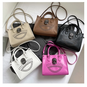 Flat lay of punk tote bags with metallic skull and rivet details in various colors