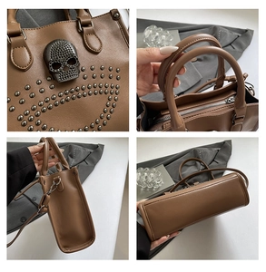 Detail of silver skull with rhinestones and metal rivets on brown vintage leather tote bag