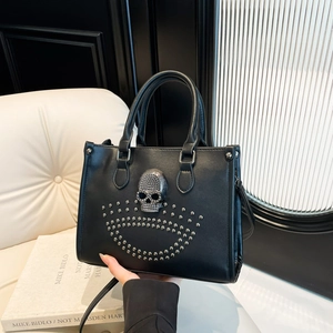 Black leather punk tote bag with silver crystal skull and rivet detailing, handheld style