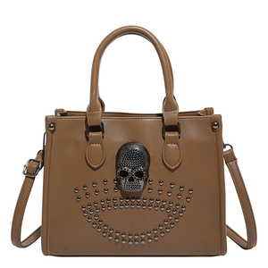 Retro tan faux leather tote bag with punk skull and stud accents with adjustable strap
