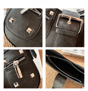 Detail of black Saffiano leather shoulder bag with silver studs and metal zipper hardware