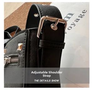 Detail of adjustable shoulder strap with silver buckle on black cross-grain leather bag