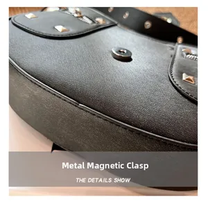 Detail of silver magnetic buckle on black Saffiano leather bag with metal rivets
