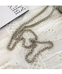 Detail of a thick silver metal chain strap with polished finish for bucket bags