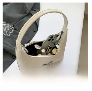 Interior capacity of the beige PU leather hobo bag showing phone and cosmetics