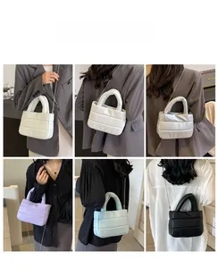 Quilted puffer bucket bags shown in five colors with silver chain straps and top handles