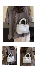Detail of silver quilted puffer bucket bag with chain strap and metallic finish