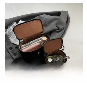Internal view of black quilted crossbody bag showing space for phone and wallet