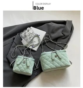 Detail of quilted leather bags with gold chain and camellia zipper in mint green color