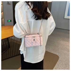 Detailed back view of pink quilted box bag showing the silver flower zippers and chain strap