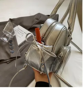 Silver metallic mini backpack with bow detail and functional pockets on a lifestyle setting