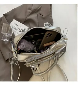 Spacious interior of silver metallic tote bag showing storage for phone and umbrella