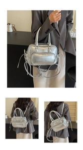 Silver metallic convertible backpack and handbag featuring sleek dual top handles