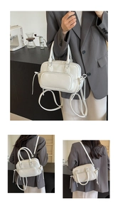 Close-up of a versatile white faux leather backpack showing multiple carrying strap options