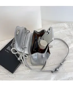 Detailed interior view of silver metallic crossbody bag with large capacity for essentials