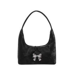 Black PU hobo shoulder bag featuring a silver metal bow decoration on a white background