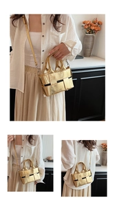 Detailed close-up of woven gold metallic handbag with adjustable shoulder strap for women