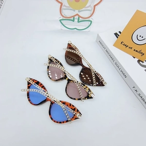 Cat eye sunglasses with gold chain detail in blue, tea and dark brown lenses