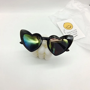 Detailed close-up of heart-shaped sunglasses with vibrant blue-green gradient mirror lenses
