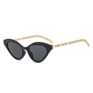 Fashionable cat eye sunglasses with black frames and decorative gold metal chain temples