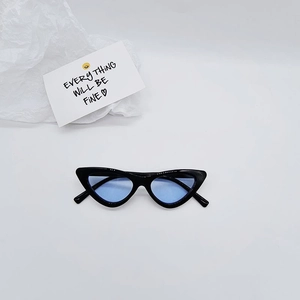 Detailed top view of retro cat-eye sunglasses with black frames and light blue lenses