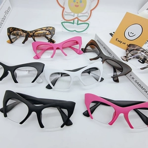Flat lay of vintage cat eye semi-rimless glasses in various colors on white background