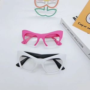 Detailed top view of pink and white cat-eye fashion eyewear frames on a white surface
