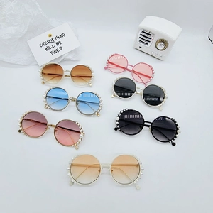 Detailed flat lay of children's round sunglasses featuring pearl frames in seven colors