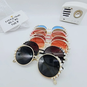 Close-up of stylish round pearl sunglasses for kids in various vintage color frames