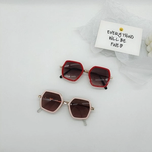 Kids hexagonal sunglasses with UV protection in red and beige diamond shaped frames