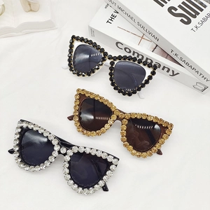 Macro view of crystal encrusted oversized cat eye sunglasses in three distinct colors