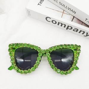 Detailed top view of cat-eye sunglasses with luxury green crystal rhinestones