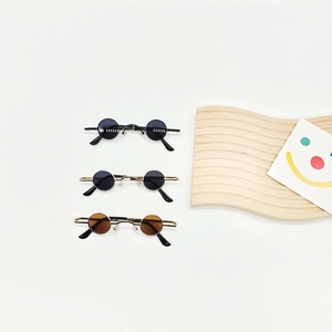 Three pairs of vintage mini round sunglasses in black, gold-black, and gold-brown colors