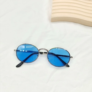 Macro detail of kids retro round blue sunglasses with rhinestone bridge and silver metal frame