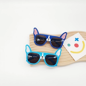 Kids French Bulldog polarized sunglasses in blue colors on a wooden wave display stand