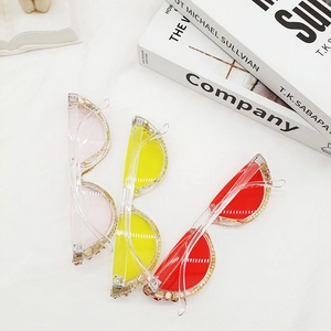 Detail of semi-rimless rhinestone sunglasses in pink, yellow and red fashion colors
