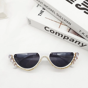 Detailed view of white semi-rimless sunglasses with luxury rhinestone embellishments