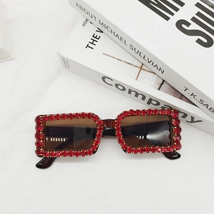 Detail of vintage rectangle sunglasses with red rhinestones and tortoiseshell temples