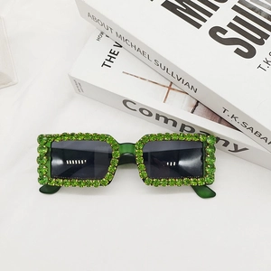 Detailed view of green translucent sunglasses frames with sparkling rhinestones decoration
