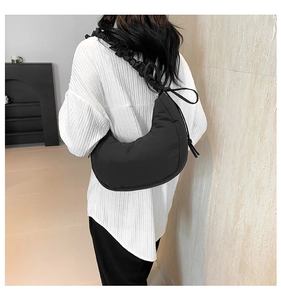 Detailed back view of a black crescent crossbody bag with stylish pleated cloud strap