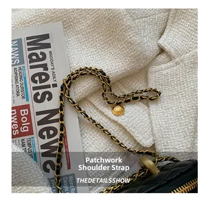 Close-up of golden metal and black leather woven chain strap on quilted crossbody bag
