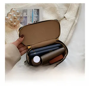 Internal view of the black quilted box bag showing spacious capacity for phone and wallet