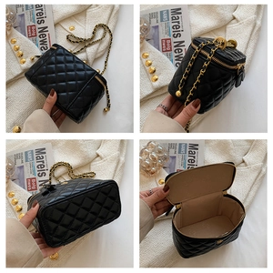 Detailed views of black quilted bucket bag with gold chain strap and spacious interior