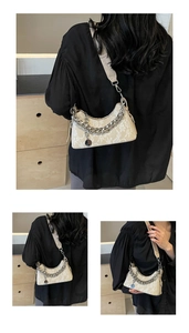 Detail of floral lace texture on cream underarm bag with silver chain and strap