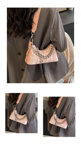 Detail of pink lace underarm bag with silver chain and crescent-shaped moon design