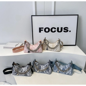 Lace拼接underarm bags in five colors with silver chain straps shown on steps