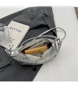 Silver crescent shoulder bag interior showing large capacity for phone and wallet
