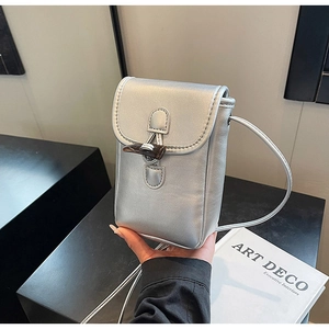 Macro view of a silver metallic crossbody phone bag with wooden toggle closure