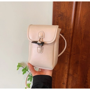 Close-up of stylish beige mini crossbody phone bag with a vintage toggle button